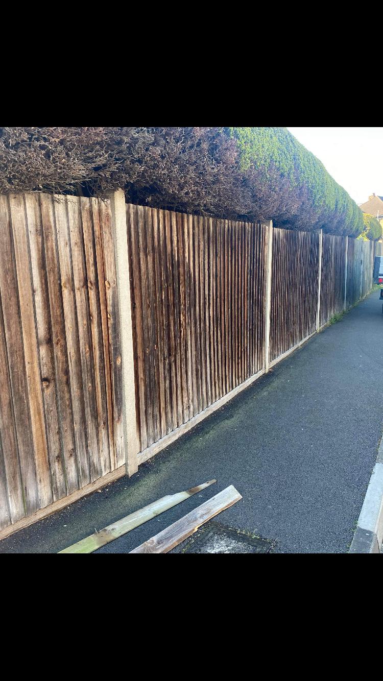 Before — damaged fence in London